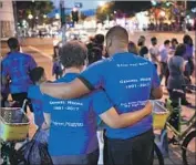  ?? Wally Skalij Los Angeles Times ?? FRIENDS and family of Gemmel Moore, 26, gather for a candleligh­t vigil in West Hollywood on Friday.