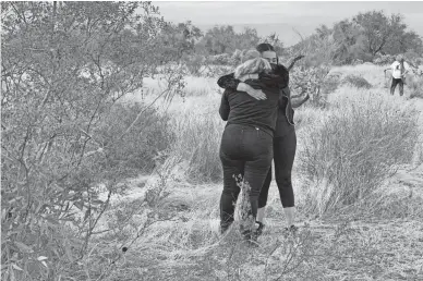  ??  ?? Cecilia Flores, founder of the Searching Mothers of Sonora, collapses into the arms of another volunteer after digging up a body found buried in a remote area west of Hermosillo, Mexico, on Dec. 3.