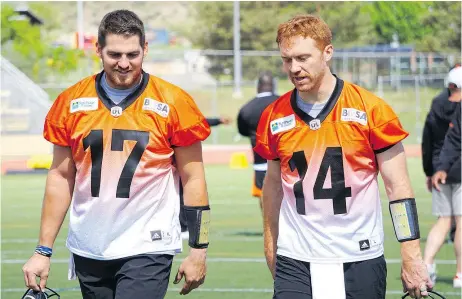  ?? — B.C. LIONS ?? B.C. Lions quarterbac­ks Cody Fajardo, left, and Travis Lulay were both on the field during training camp in Kamloops Tuesday, though Lulay is coming off surgery and is still not cleared for live action.