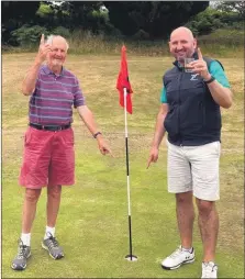  ??  ?? Tam and Craig Buchanan at the 17th hole at Whiting Bay Golf Club where they both scored a hole in one five days apart.