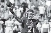  ?? MICHAEL AINSWORTH AP ?? Oklahoma quarterbac­k Spencer Rattler converted a 2-point conversion against Texas in the fourth overtime Saturday in Dallas to lead the Sooners.