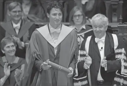  ?? NEIL HANNA, GETTY IMAGES ?? Prime Minister Justin Trudeau is awarded an honorary degree at the University of Edinburgh on Wednesday. The award is in recognitio­n of his achievemen­ts as a public servant with strong commitment­s to equality and diversity. Trudeau received the degree...