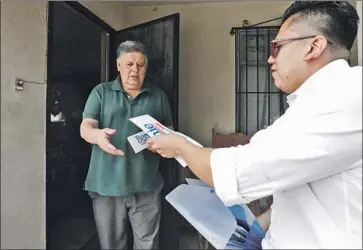  ?? Myung J. Chun Los Angeles Times ?? RICARDO ALONZO UGALDE, right, stumps for Bernie Sanders in February. He wasn’t sure he was going to vote after Sanders left the race. Now he’s supporting Joe Biden, despite him being too moderate for his tastes.