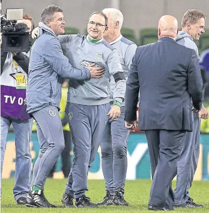  ??  ?? Ireland coach Martin O’Neill, centre, hugs his deputy Roy Keane after the second-leg play-off against Bosnia-Herzegovin­a.