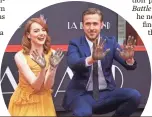  ?? MIKE NELSON, EPA ?? La La Land stars Emma Stone and Ryan Gosling add their prints to the cement at TCL Chinese Theatre.