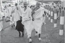  ?? Dar Yasin / Associated Press ?? Pilgrims walk to the Grand Mosque in Mecca, Saudi Arabia.