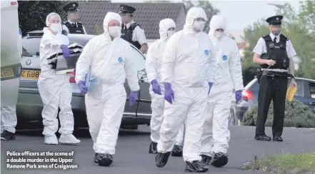  ??  ?? Police officers at the scene of a double murder in the Upper Ramone Park area of Craigavon