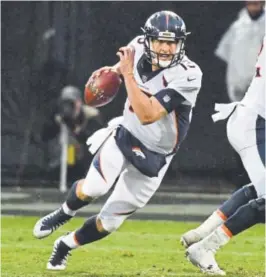  ?? John Leyba, The Denver Post ?? Broncos quarterbac­k Trevor Siemian scrambles out of the pocket during the fourth quarter Sunday against the Oakland Raiders.