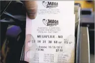  ?? Nam Y. Huh / Associated Press ?? The Mega Millions jackpot in Tuesday’s drawing is an estimated $1.6 billion. On Saturday, a Powerball ticket sold in Connecticu­t matched five numbers to win $1 million.