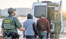  ??  ?? CAUGHT: Border Patrol agents detain a group of Guatemalan migrants (above) in Sunland Park, NM, last week. Among those caught was a woman carrying a plastic rosary (below). “I am not alone,” she said. “God is with me.”