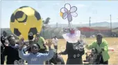  ??  ?? Pupils play with bubbles at the kite festival at Manyanani Park in Khayelitsh­a.