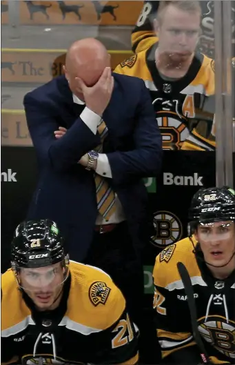  ?? STUART CAHILL — BOSTON HERALD ?? Boston Bruins head coach Jim Montgomery buries his head in his hand as the Bruins play the Panthers in game 5 of the first round of NHL playoffs at the Garden on April 26, 2023 in , Needham, MA. .