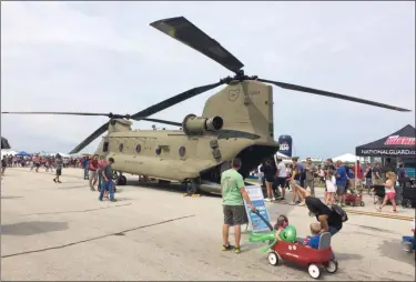  ?? CHAD FELTON — THE NEWS-HERALD ?? Cleveland National Air Show attendees marvel at a CH-47F Chinook transport aircraft, courtesy of the Ohio Army National Guard, Sept. 1 at Burke Lakefront Airport. The traditiona­l Labor Day Weekend event attracts over 100,000 people.