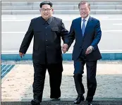  ?? AP/Korea summit press pool ?? Kim Jong Un (left) crosses into South Korea today with South Korean President Moon Jae-in, becoming the first North Korean leader to enter the south since the early 1950s as they begin a historic summit after months of heightened tensions.