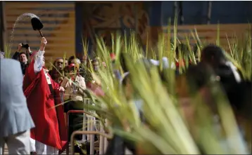  ?? PHOTO BY AXEL KOESTER ?? Archbishop José H. Gomez performs a blessing of the palm branches before Palm Sunday Mass at the Cathedral of Our Lady of the Angels in Los Angeles on Sunday.