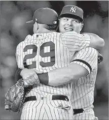  ?? Emilee Chinn Getty Images ?? NEW YORK YANKEES Gio Urshela (29) and Luke Voit celebrate after the team captures its first division title since 2012.