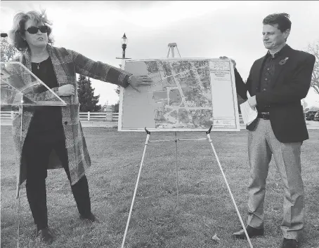  ?? DAN JANISSE ?? Amherstbur­g Mayor Aldo DiCarlo and Amico Properties Inc. vice-president of developmen­t Cindy Prince unveil plans for a new $120-million riverfront developmen­t project beside the site of the former Duffy’s Tavern during a news conference Friday.