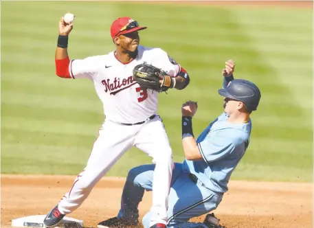  ?? MITCHELL LAYTON/GETTY IMAGES ?? Nationals infielder Alcides Escobar forces out Blue Jays runner Reese McGuire at second base on Wednesday.