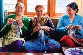  ?? Contribute­d ?? Indian women knitting socks for Fazl Socks, a social enterprise started by Kelowna couple Mike Gunn and Vanessa Tse that raises money for orphanages in North India and provides fair wages to the women who make the socks.
