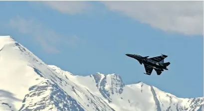  ??  ?? An Indian fighter jet soaring high above Ladakh.