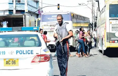  ?? NORMAN GRINDLEY/CHIEF PHOTO EDITOR ?? Police on patrol in downtown Kingston yesterday despite the sick-out by some of their colleagues.