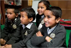  ?? Credit: Blair Millar ?? Below right: Students at Chaurikhar­ka school listening to stories read by the Kiwi trekkers.