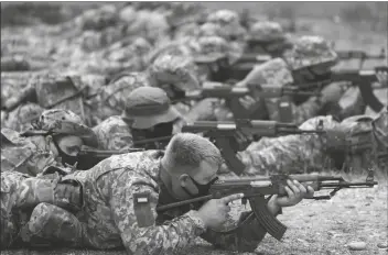  ?? FRANK AUGSTEIN/AP ?? UKRAINIAN VOLUNTEER MILITARY RECRUITS take part in an urban battle exercise whilst being trained by British Armed Forces at a military base in Southern England on Monday.