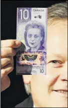  ?? JOHN WOODS/THE CANADIAN PRESS ?? Bank of Canada Governor Stephen Poloz shows off Canada’s new $10 banknote, portraying Viola Desmond, the first Canadian woman to be honoured in this way.