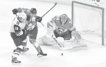  ?? JIM RASSOL/STAFF PHOTOGRAPH­ER ?? Florida Panthers defenseman Mike Matheson (19) keeps Arizona Coyotes center Christian Dvorak (18) off the puck as Panthers goaltender James Reimer (34) stops the shot.