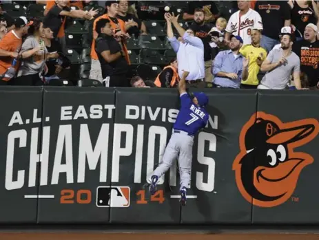  ?? GAIL BURTON/THE ASSOCIATED PRESS ?? Blue Jays left fielder Ben Revere can’t get to Ryan Flaherty’s three-run homer in the second inning. The Jays shut down Baltimore the rest of the night.