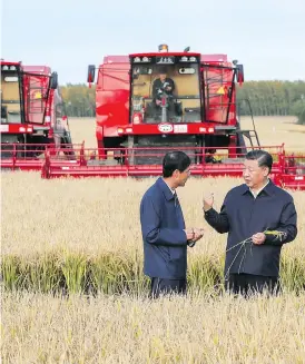  ?? XIE HUANCHI/XINHUA VIA THE ASSOCIATED PRESS ?? President Xi Jinping, right, inspects a farm in China’s northeast. China has said the trading veto clause in the USMCA “interferes with the sovereignt­y of others.”