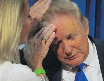  ?? THE ASSOCIATED PRESS/FILES ?? Donald Trump asked Claire Rouillard, a New Hampshire legislator, to confirm that his hair is real during a rally during his bid for the Republican nomination in the state in 2015.