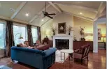  ??  ?? A vaulted ceiling and a cozy fireplace add appeal to the family room.