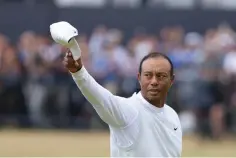  ?? The Associated Press ?? ■ Tiger Woods gestures to the crowd at the end of his second round of the British Open Friday on the Old Course at St. Andrews, Scotland.