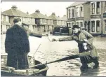  ?? ?? Milk delivery by boat in flood-hit Sheerness