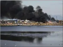  ?? ?? Vallejo firefighte­rs try to make access to a fire at a homeless