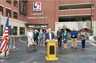  ?? DAN SOKIL — DIGITAL FIRST MEDIA ?? SEPTA General Manager Jeff Knueppel, center, speaks about the Lansdale parking garage and the impact it will have on the local community ahead of a ribbon-cutting ceremony on Friday morning.