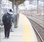  ?? H John Voorhees III / Hearst Connecticu­t Media ?? Justin Alam, a student at Western Connecticu­t State University, waits for a Metro North train at the Danbury train station in 2019.