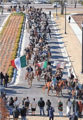  ?? PHOTOS BY STEVE SISNEY FOR THE OKLAHOMAN ?? Horses and riders participat­e in a procession­al for the feast day of St. Juan Diego on Saturday as it ends at Tepeyac Hill at the Blessed Stanley Rother Shrine on Saturday in Oklahoma City.