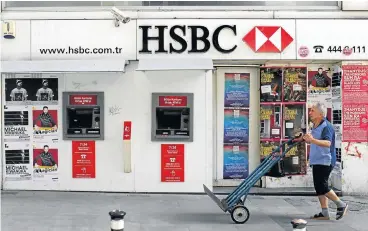  ?? /Reuters ?? Change: A man walks past a closed HSBC bank branch in Istanbul, Turkey. The banking group has chosen John Flint to take over the reins from CEO Stuart Gulliver.