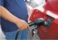  ?? LUIS SÁNCHEZ SATURNO/THE NEW MEXICAN ?? Gas prices boil down to simple economics — supply and demand, with complicati­ng factors such as local competitio­n thrown in.