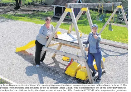  ?? NICOLE SULLIVAN/CAPE BRETON POST ?? Tiny Town Daycare co-director Vivian Morrison (right) gives a thumbs up to reopening daycares in Nova Scotia on June 15. Her eagerness to get students back is shared by her co-director Teresa Gillam, who standing next to her in one of the play areas in the backyard of the childcare facility they have worked at since the 1980s. Provincial COVID-19 infection prevention guidelines for childcare settings dictate number of licensed students is temporaril­y cut in half, drops-offs and pick-ups must be staggards and no student or staff can be at the facility if aren’t feeling well.