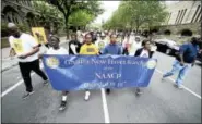  ?? ARNOLD GOLD / HEARST CONNECTICU­T MEDIA ?? Left to right, Marquis McFadden, 14, Kaleb Walton, 17, Julian Brown and Kiara Brown, 18, of New Haven carry the NAACP banner to lead a Silent Protest Parade by the Greater New Haven Branch of the NAACP down Elm Street on the way to the New Haven Green...