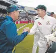  ??  ?? Justin Langer and Tim Paine celebrate the victory.