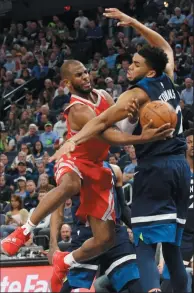  ?? AP PHOTO/JIM MONE ?? Houston Rockets' Chris Paul, left, attempts a shot around Minnesota Timberwolv­es' Karl-Anthony Towns during the second half of Game 4 in an NBA basketball first-round playoff series Monday in Minneapoli­s.