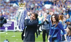  ??  ?? Chelsea’s manager Antonio Conte holds the English Premier League trophy beside his wife Elisabetta Photo: AP