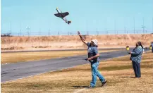  ?? COURTESY OF GREG RULLMAN ?? Greg Rullman, president of the Duke City Electric Flyers Club, launches a P-51 Mustang model aircraft at Balloon Fiesta Park.