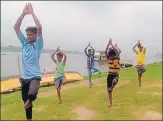  ?? SOURCED PIC ?? ■
In absence of training, young rowers doing yoga and exercise in Prayagraj.