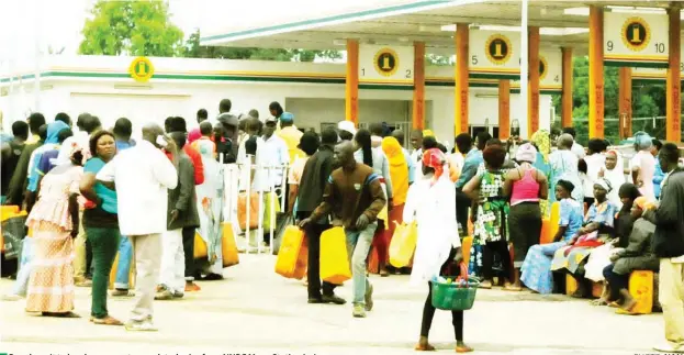  ?? PHOTO: ?? People wait to buy kerosene at a regulated price from NNPC Mega Station in Jos NAN