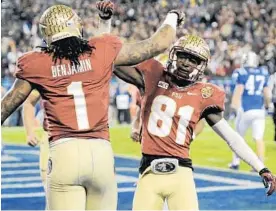  ?? JEFF SINER/MCT ?? Receiver Kenny Shaw, right, congratula­tes receiver Kelvin Benjamin after he scored a TD.